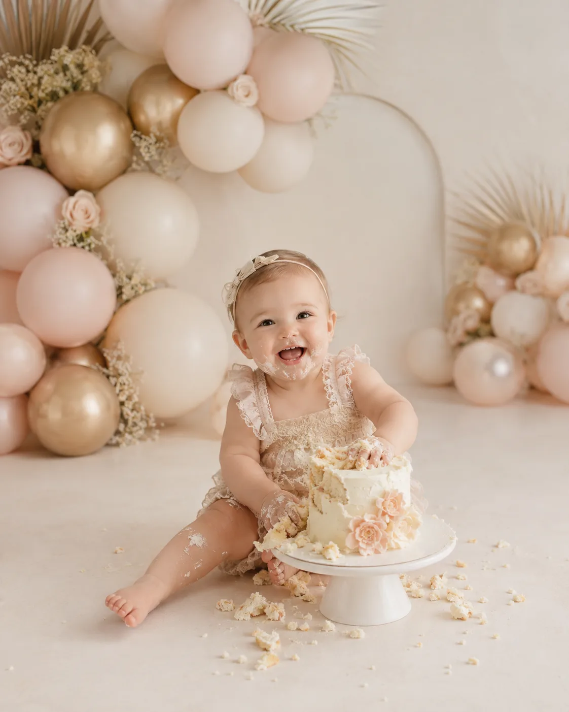 One-year-old laughing during a cake smash session, Tampa milestone photography style sample