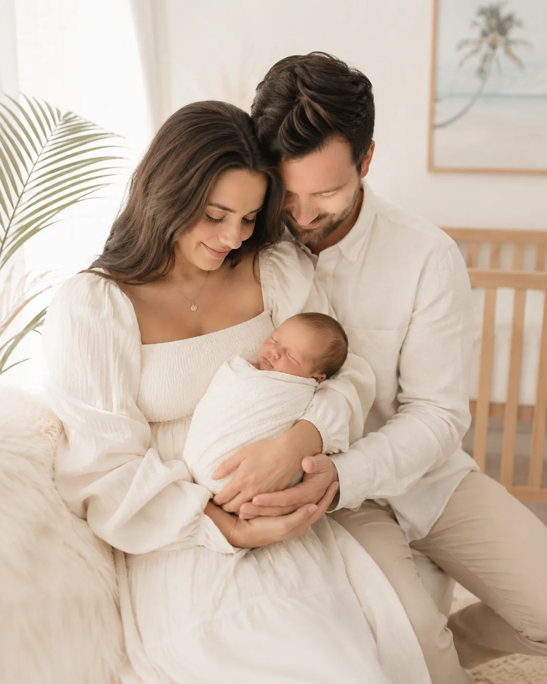 Parents holding their newborn baby together during an in-home family photography session in Tampa